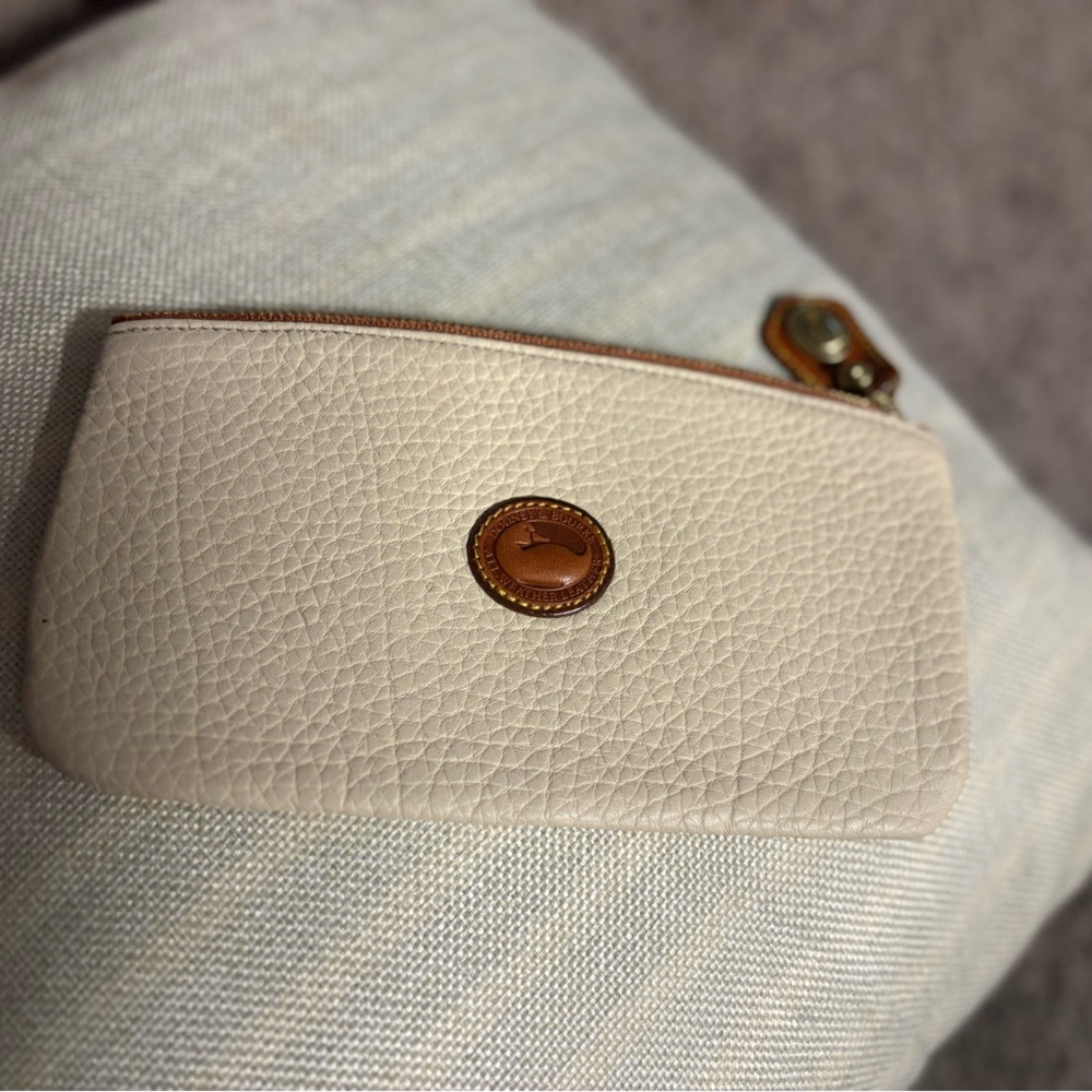 Dooney& Bourke leather Zip up bag. Light beige with tan trim.